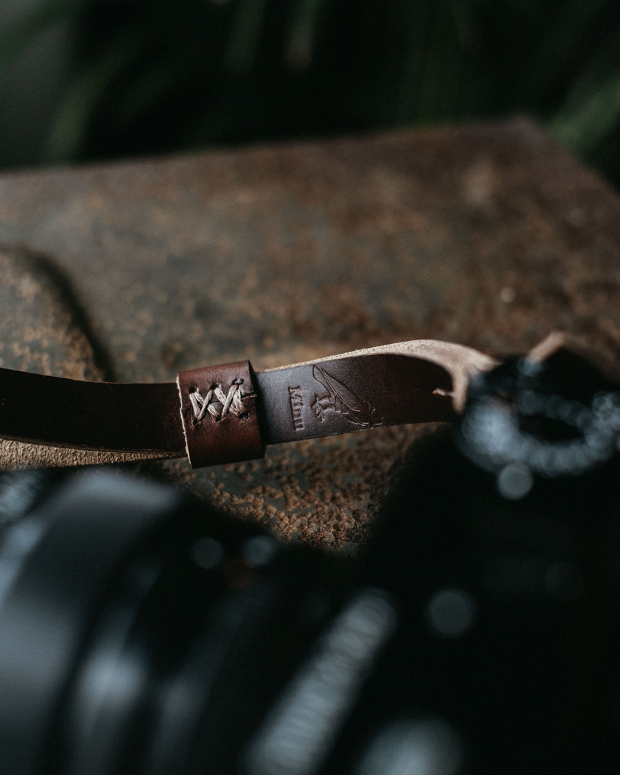 stitching and logo details on camera strap